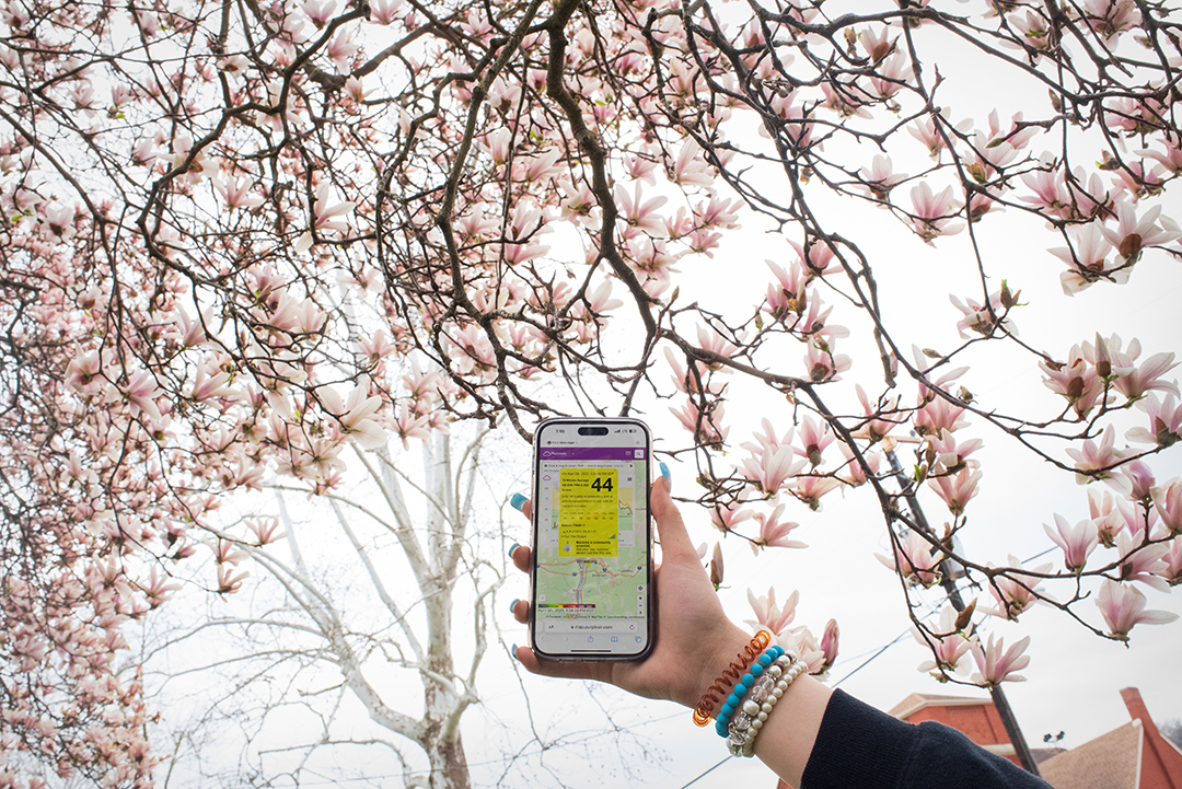 A student at Bellaire High School holds a phone with an app that allows her to track air quality from small low-cost air monitors that Yuri Gorby helped install across the Ohio Valley. (Photograph by Abby Craig)