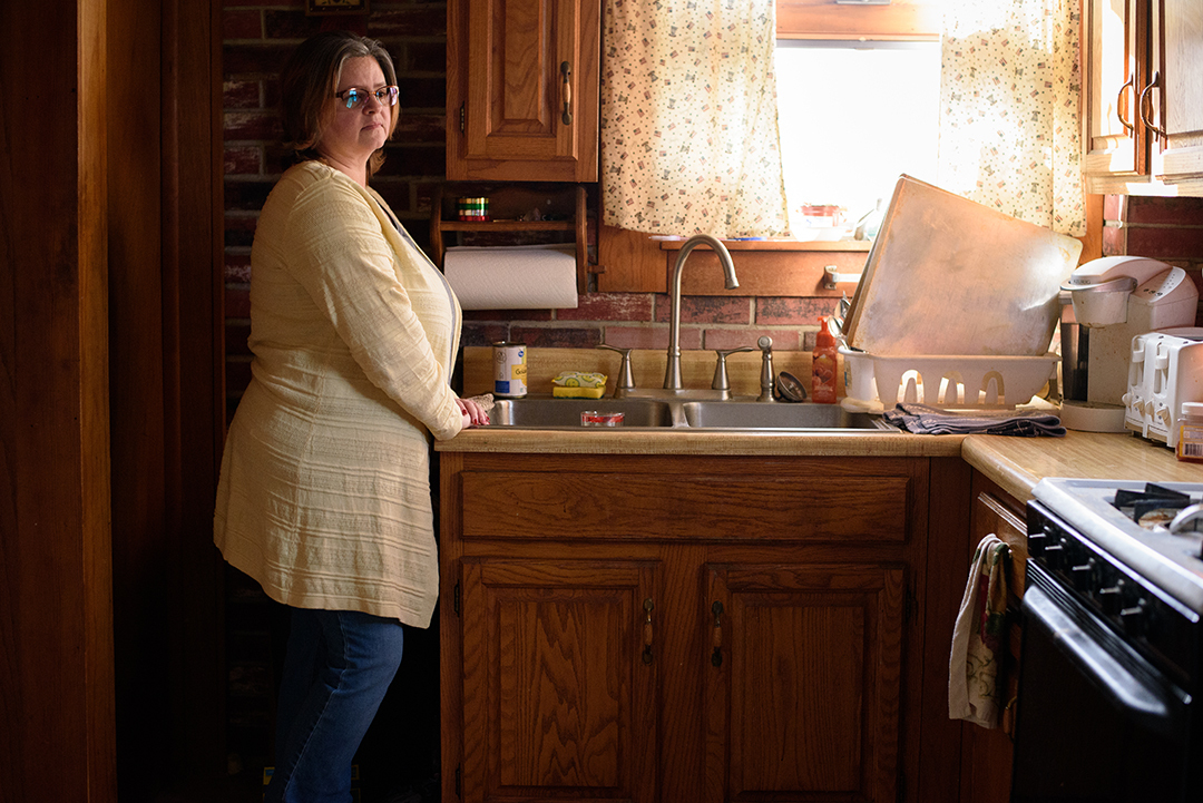 Erin Smith, a resident of Bridgeport stands in her kitchen. Even though Bridegport's water supply now comes from Martins Ferry, which is safe to drink, Erin primarily uses bottled water. In a online poll taken by the Wheeling Intelligencer in November of 2022, only 46% of people believe that the water in the region is safe to drink. (Photograph by Maddie Miller)