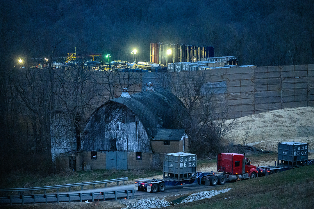 Trucks deliver frac sand to the well pad. A single frac pad may use up to 10,000 tons of sand and 4 million gallons of water. (Photograph by Lyndzey Crupe)